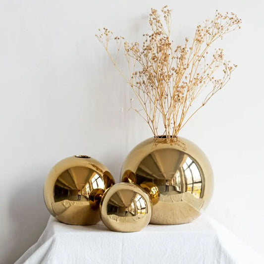 Golden Plated Sphere Vase – Elegant Ceramic Décor for Floral Arrangements, Crafted from ceramic with a luxurious golden plating, this spherical vase adds a touch of elegance to any space. Perfect for displaying artificial